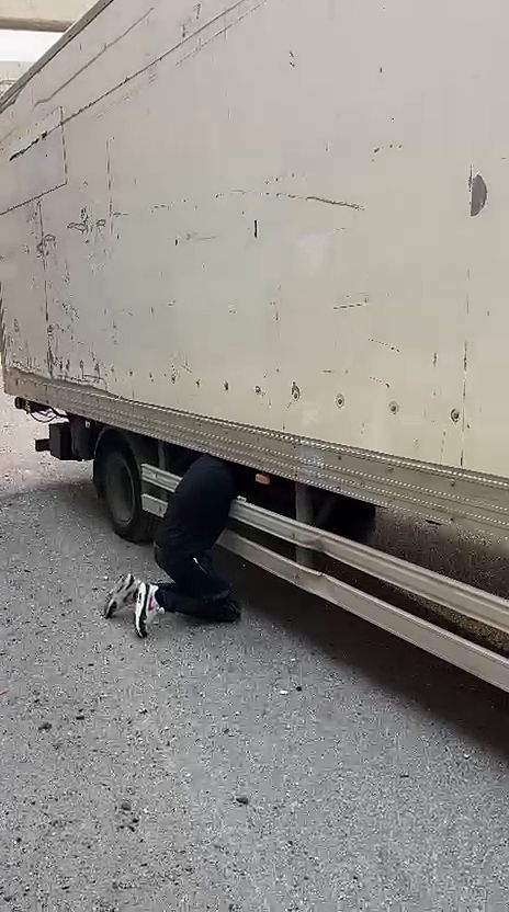 עבודה מתחת למשאית ארגז לשחרור הגלגל הרזרבי
